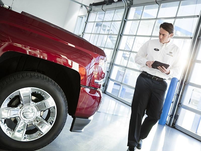 a man inspecting car in showroom