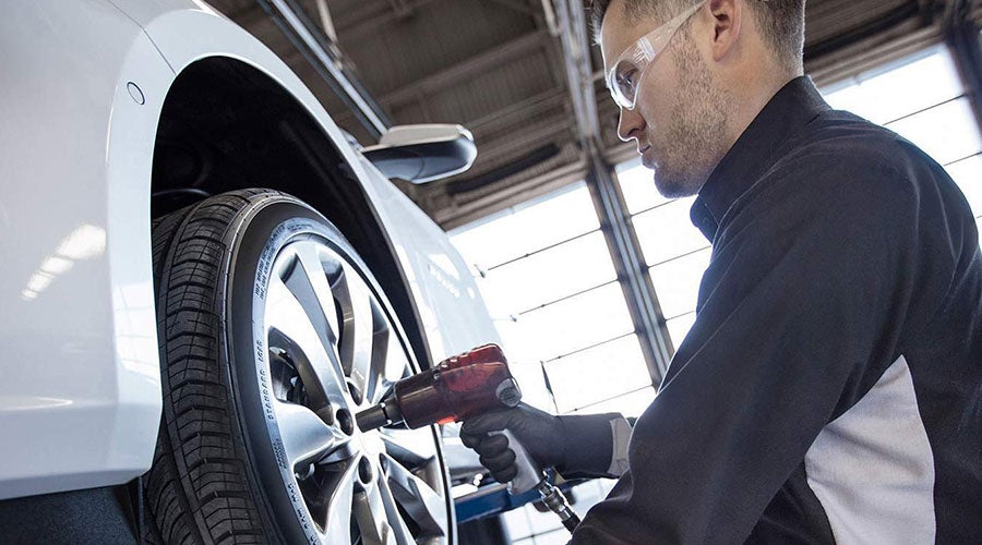 Man fixing Tire of a Vehicle